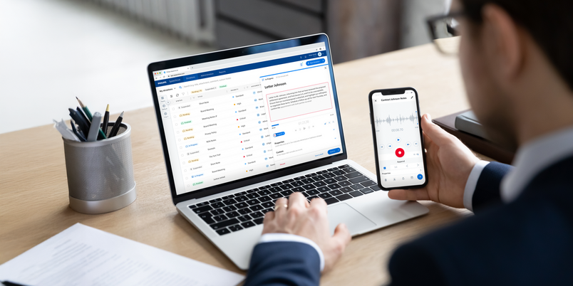 Business marketer using professional app for marketing data analyzing on laptop and smartphone screens, studying financial graphs, comparing diagrams on phone and computer.